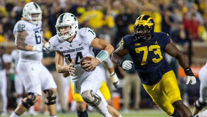 Oct. 7: Brian Lewerke rushes past Michigan defensive lineman Maurice Hurst for a 14-yard touchdown in the first quarter, giving the Spartans a 7-3 lead.