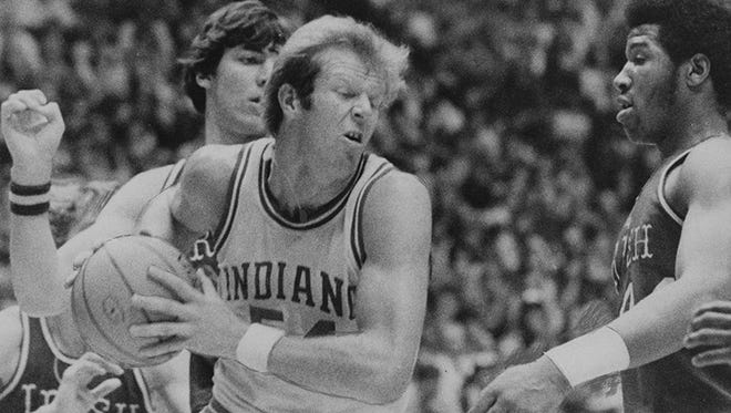 Indiana's Kent Benson takes a rebound away from Bruce Flowers (34), Bill Laimbeer and Adrian Dantley (right) of Notre Dame in 1975.