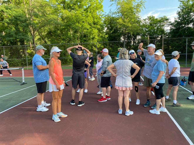 Black Mountain pickleball players wait their turn while others play.