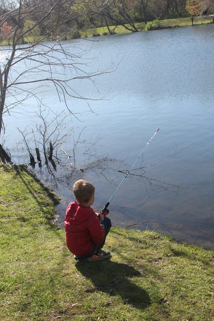 Beau Kirchner fishes at Buncombe County Parks and Recreation's kids fishing tournament at Charles D. Owen Park April 13, 2024.