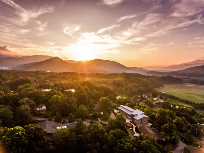 Sun sets over the Warren Wilson College campus in this drone photo of Myron Boon Hall, at lower right.