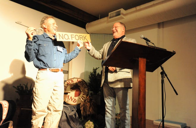 Van Burnette, left, a seventh-generation resident of the North Fork community in Black Mountain, names Wendell Begley an "honorary member of the Burnette clan," during a ceremony recognizing Begley for 21 years of serving as the chair of the Swannanoa Valley Museum & History Center Board of Directors.