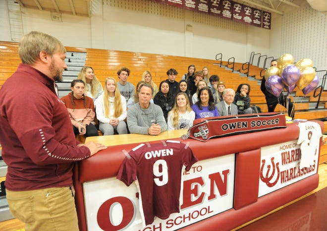 Owen soccer head coach David Fiest congratulates Mikayla Roseman on signing with Western Carolina University on Nov. 13.