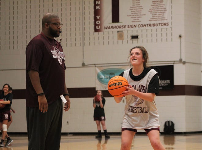 First-year Warlassies head coach Anderson Bynum distracts freshman Carly Hancock at the free throw line during practice, as Owen prepared to open its season on the road against Thomas Jefferson Classical Academy.