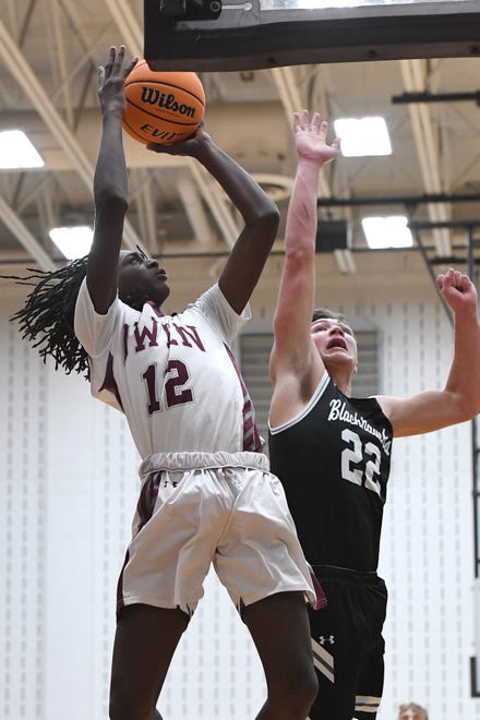 Owen's Geordan Haggins goes up for a shot against North Buncombe's Caleb Lominac during their game at Owen High School on Jan. 2, 2020.