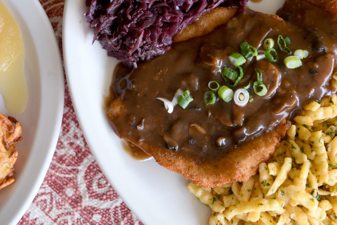 The Jagerschnitzel at Berliner Kindl German Restaurant in Black Mountain is breaded pork schnitzel topped with mushroom sauce and is served with German spaetzle and red cabbage.