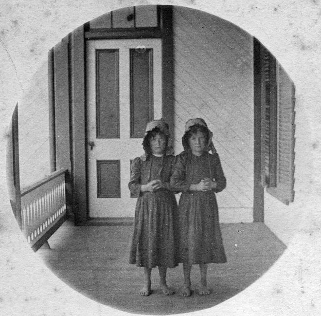 This photo, taken by Gertrude Sprague, shows two young visitors on the porch of the Black Mountain Hotel at the turn of the 19th century.