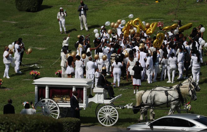 A horse-drawn hearse carrying the casket bearing the remains of Rayshard Brooks is seen at the Forest Hills Memorial Gardens cemetery on the day of his funeral on June 23, 2020 in Atlanta, Ga.