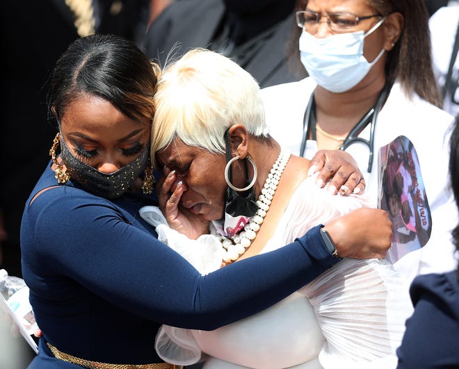 Tomika Miller, right, leaves the funeral service for her husband Rayshard Brooks.