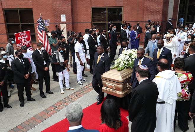The casket bearing the remains of Rayshard Brooks is carried after his funeral service.