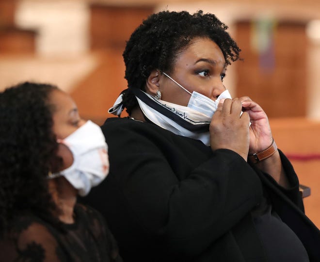 Former candidate for governor of Georgia Stacey Abrams wipes her face while attending the Rayshard Brooks funeral.