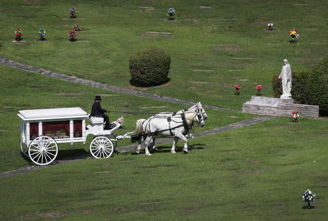 A horse-drawn hearse carrying the casket bearing the remains of Rayshard Brooks is seen at the Forest Hills Memorial Gardens cemetery on the day of his funeral on June 23, 2020 in Atlanta, Ga. Brooks was killed June 12 by an Atlanta police officer after a struggle during a field sobriety test in a Wendy's restaurant parking lot.