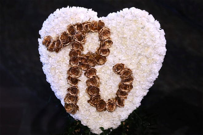 An arrangement of white flowers in the shape of a heart bears gold colored roses for his initial during Rayshard Brooks' funeral.
